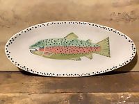 Full view of oval platter showing fish design and dotted rim