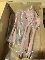 Set of pink silicone utensils in box, all bagged