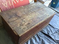 Top view of closed wooden chest with worn surface