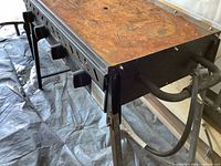 Full view of Niclan griddle showing rusted cook surface, control panel, folding legs