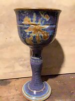 Full view of blue glazed pottery chalice goblet, stem and base visible