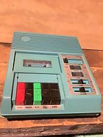 Top view of Telex teal cassette recorder showing transport buttons and cassette window