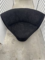 Top view of single curved corner sectional module upholstered in dark charcoal fabric