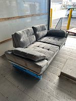 Full view of sofa showing overall style and metal base