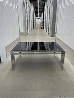 Full view of coffee table showing glass top and chrome legs