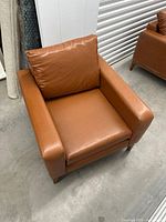 Front angle of cognac leather armchair