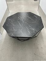 Top view showing octagonal black surface with white veining