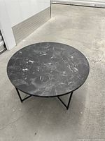 Top view of round black marble-pattern coffee table