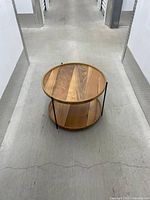 Overhead view of round two-tier walnut-finish table