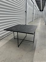 Perspective view of square coffee table showing top pattern and metal base