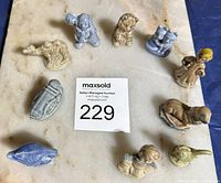 Group shot of all 10 Wade miniatures around lot tag