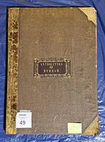Front cover showing brown cloth, worn leather spine and corners, gilt title label