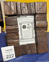 Full view of framed Roman coin with auction tag