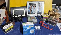 Overview of lot showing digital photo frame, Euro Design frames, Maxell DVD-R pack, cassette tapes, CDs, wooden items, clamp and hook