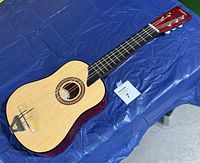 Front view of small acoustic guitar on table