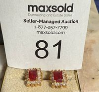 Front view of both stud earrings with red center stones and clear accents