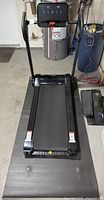 Full view of SuperFit treadmill set up on floor mat
