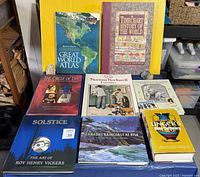 All eight hardcover books arranged on table for full lot view