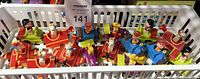 Basket containing fourteen colorful Peanuts character push-down vehicles