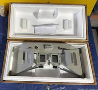 Stereoscope inside fitted foam interior of wooden case
