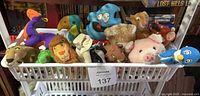 Full bin showing all plush toys lined up