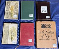 Six books laid flat showing front covers with date stickers