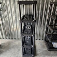 Front view of full five-tier shelving showing shelf spacing and grid design