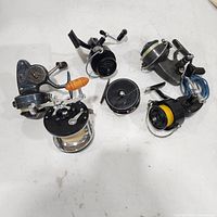 Group shot of five spinning reels and spare spool