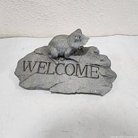 front view of concrete frog welcome sign