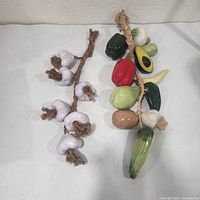 Both ceramic garlands laid flat showing full contents