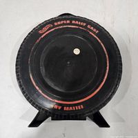 Front of tire-shaped carrying case showing Hot Wheels Super Rally Case label
