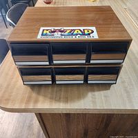 Two cassette storage boxes stacked showing drawer fronts