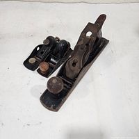 Top view of three metal hand planes showing overall design and sizes