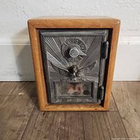 Front view of oak coin bank with metal postal door