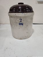 Front view showing Ruckels mark, 2-gallon stamp and lid