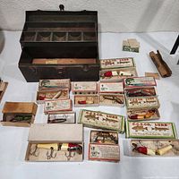 Overview of tackle box and boxed lures on table