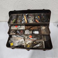 Overall view of open brown tackle box with contents