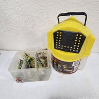 Frabill Flow Troll bucket beside tackle box full of lures