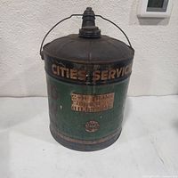 Front view showing Cities Service logo, green paint and rust