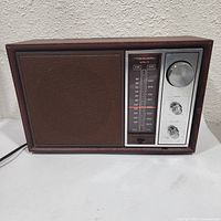 Front view showing speaker grille, tuning scale, knobs