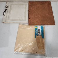 Two scrapbooks and sealed refill pages overview