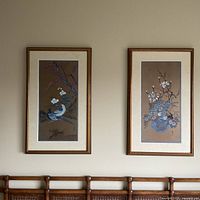 Both framed prints hanging side by side