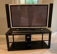 Front view of Dell plasma TV on glass stand