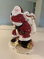 Ceramic Santa with open sack vase standing on base