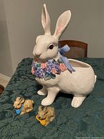 Front view of Fitz and Floyd rabbit planter with two small rabbit figurines