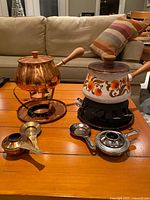 Overall view of both fondue sets on table