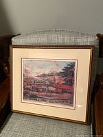 Framed print on chair showing full frame and mat