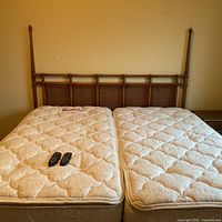 Split king bed with mattresses, remotes and headboard