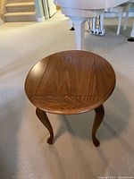 Top view of oak round side table showing veneer pattern and finish