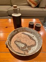 Set showing dish, jug, two cups on table